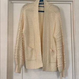 Oversized cardigan with pom sleeves